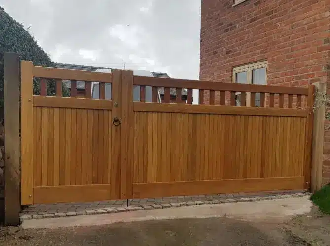 Link to our range of driveway gates that can be made uneven to make it easier for pedestrian access. Showing a hardwood gate with a small section on the lefthand side for pedestrian access and you can open both wooden gates to allow vehicle access.