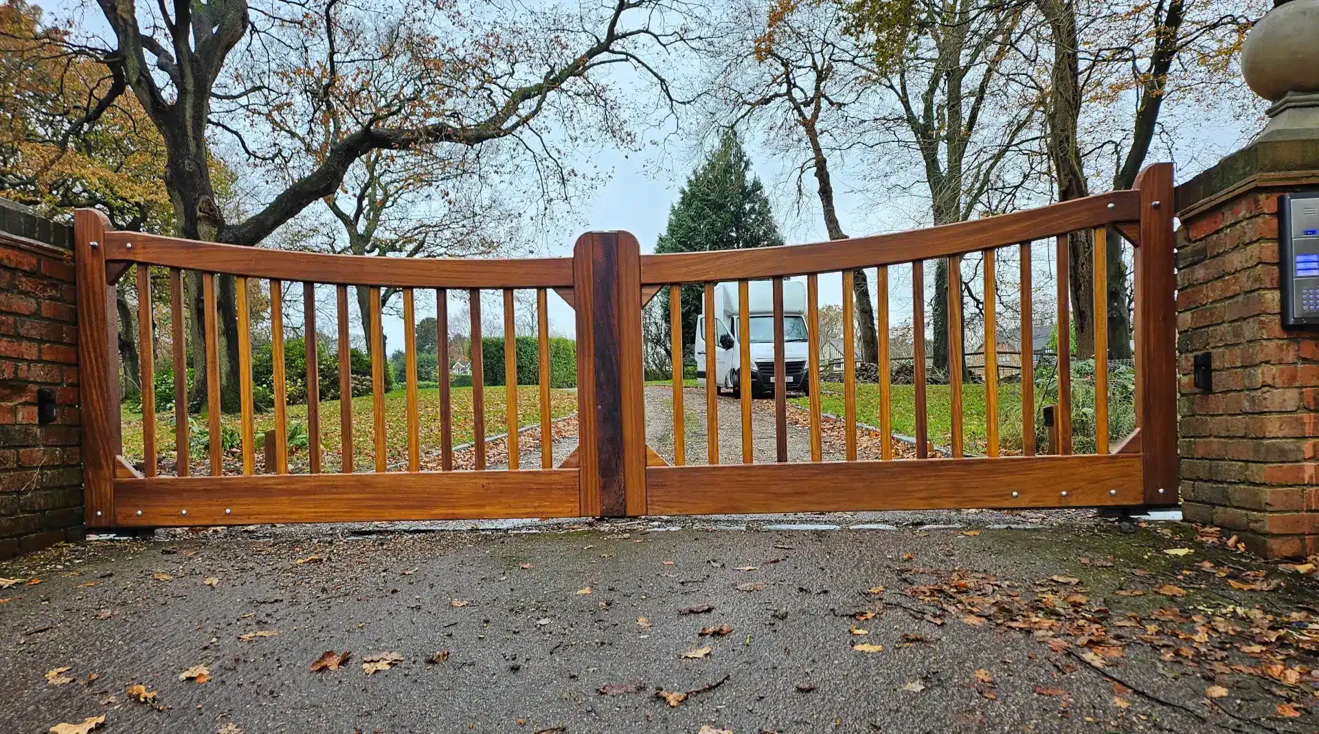 front view of electric gates made from iroko hardwood using underground automation