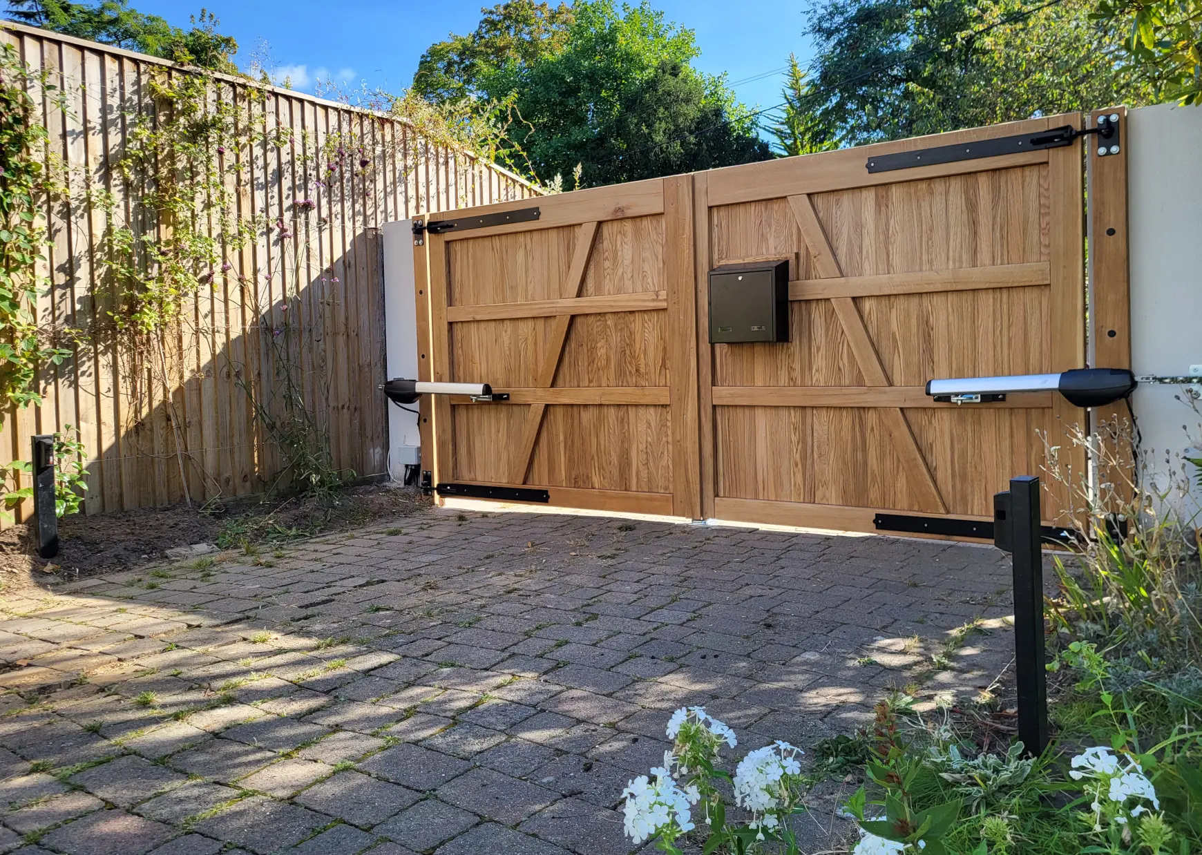 electric gate shown from the rear made from oak with a letterbox