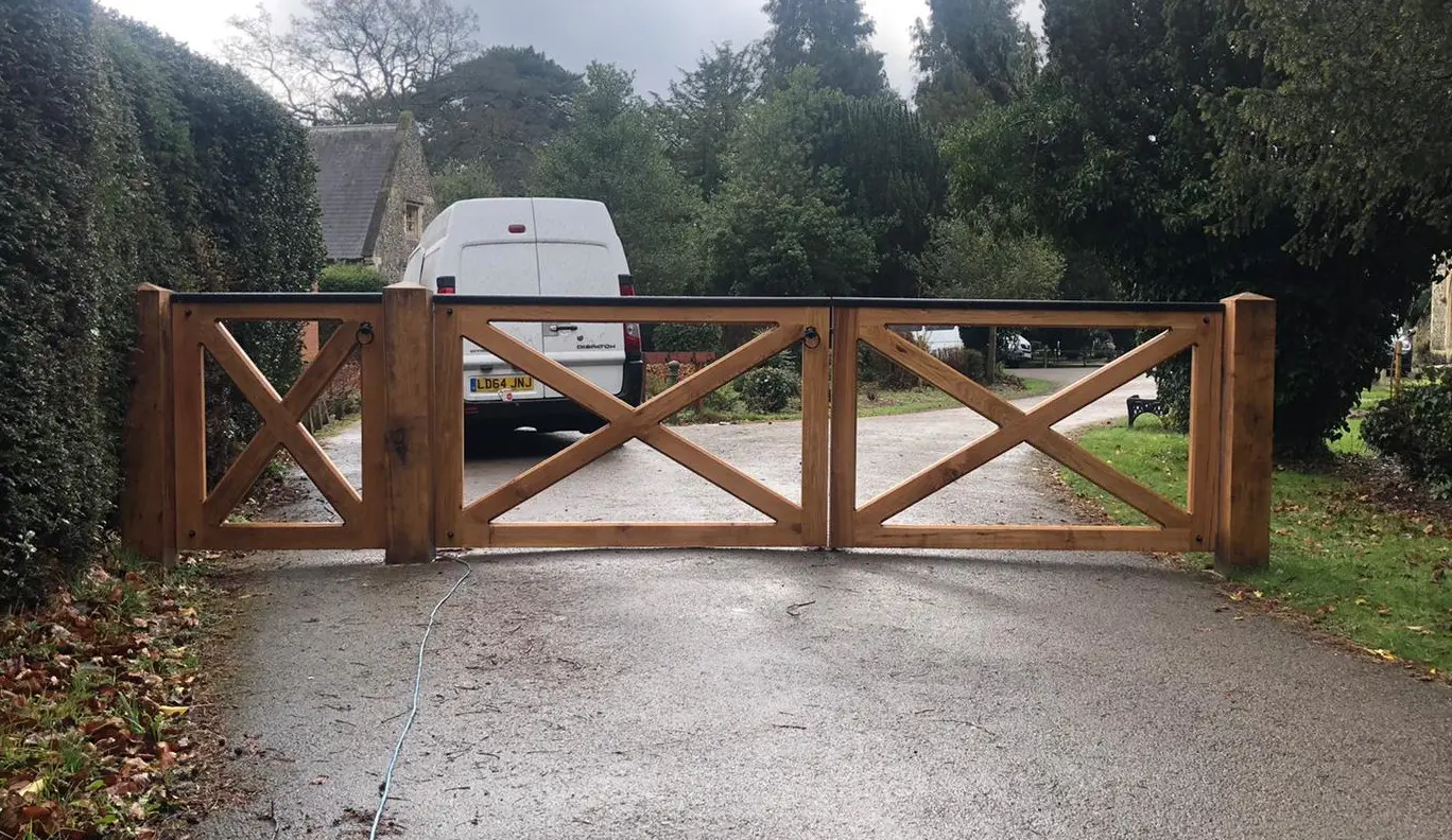 Outside view of traditional looking oak driveway and matching pedestrian gates looking at the front