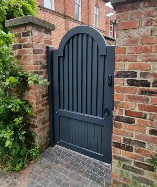 Garden painted gate using RAL7016 fitted between two brick piers with a coded lock.